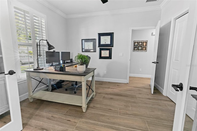 home office featuring french doors, ornamental molding, and light hardwood / wood-style flooring