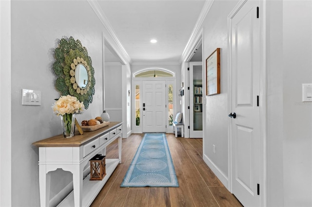 foyer entrance featuring hardwood / wood-style flooring and crown molding