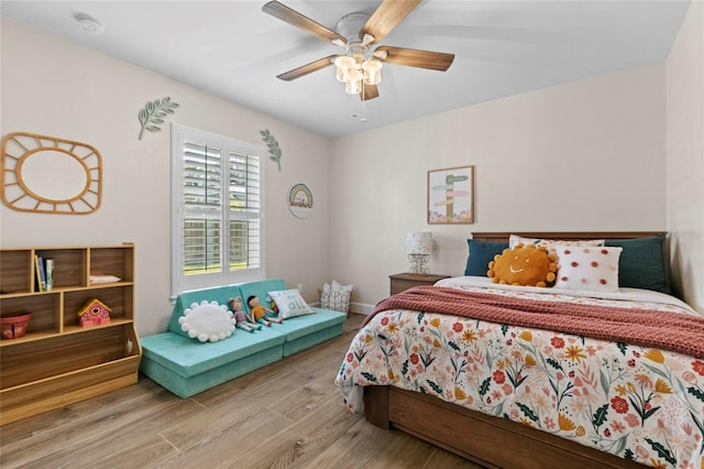 bedroom with hardwood / wood-style floors and ceiling fan