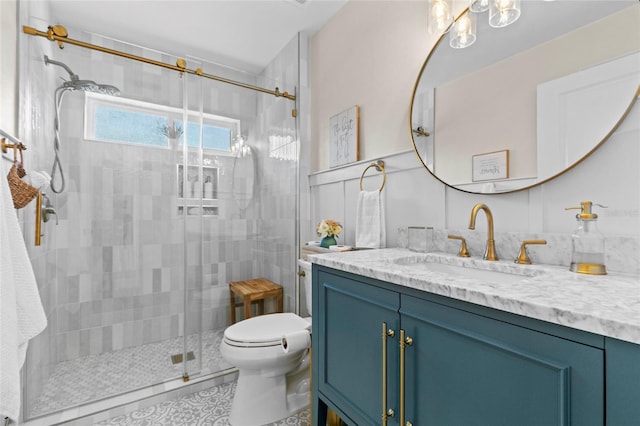 bathroom featuring vanity, toilet, and a shower with shower door