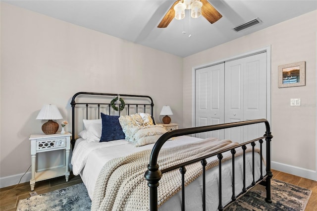 bedroom with a closet, hardwood / wood-style flooring, and ceiling fan