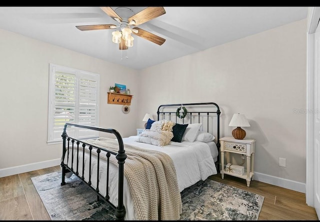 bedroom with hardwood / wood-style flooring and ceiling fan