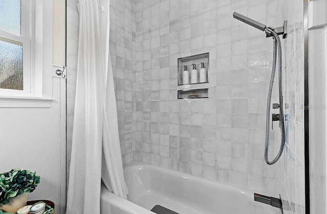 bathroom with shower / bath combo with shower curtain