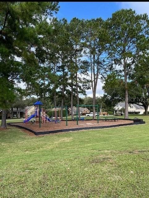 view of playground with a lawn