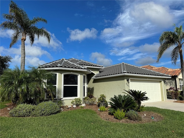 5101 Pine Shadow Ln, North Port, FL 34287 - mediterranean / spanish home featuring a garage, driveway, stucco siding, a tile roof, and a front lawn