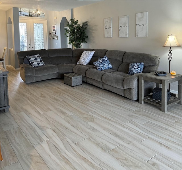 5101 Pine Shadow Ln, North Port, FL 34287 - living area featuring light wood finished floors, arched walkways, and a chandelier