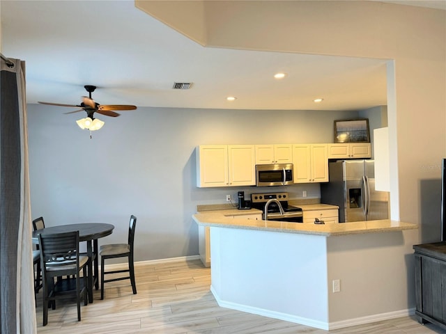 5101 Pine Shadow Ln, North Port, FL 34287 - kitchen featuring appliances with stainless steel finishes, recessed lighting, ceiling fan, light wood-style flooring, and baseboards