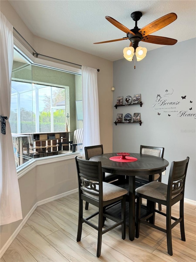 5101 Pine Shadow Ln, North Port, FL 34287 - dining space featuring a ceiling fan, baseboards, and light wood finished floors