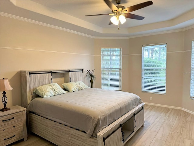 5101 Pine Shadow Ln, North Port, FL 34287 - bedroom with a raised ceiling, light wood finished floors, ceiling fan, baseboards, and ornamental molding