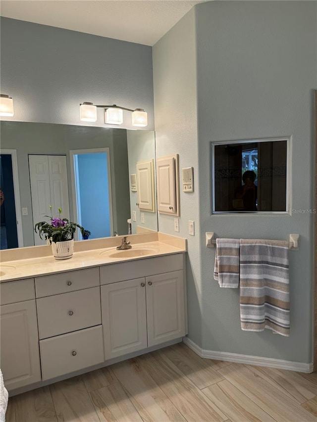 5101 Pine Shadow Ln, North Port, FL 34287 - full bath with double vanity, wood finished floors, and baseboards