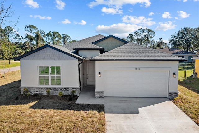 single story home featuring a front lawn and a garage