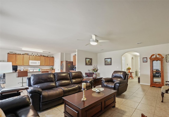 living room featuring light tile patterned flooring and ceiling fan