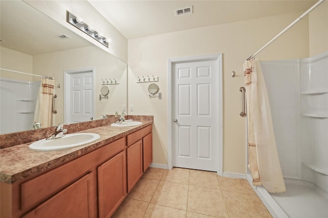 bathroom with vanity, walk in shower, and tile patterned flooring