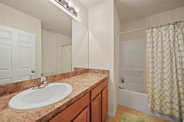 bathroom featuring vanity, shower / bath combo with shower curtain, and tile patterned floors