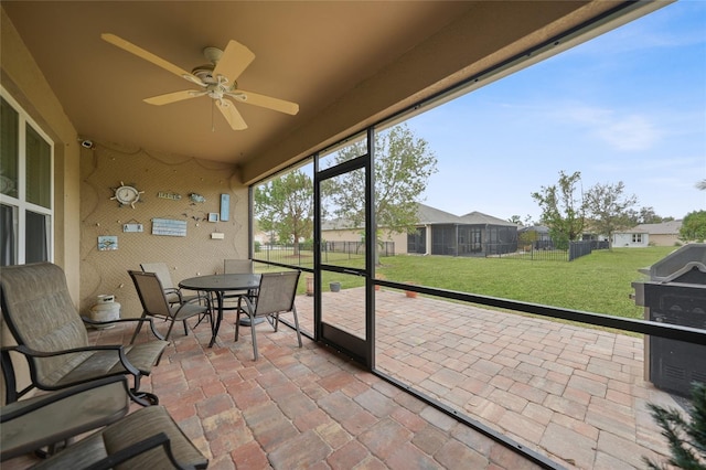 sunroom / solarium with ceiling fan