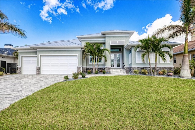1450 Kiwi Ct, Punta Gorda, FL 33950 - prairie-style home with french doors, a standing seam roof, stone siding, a garage, and stucco siding