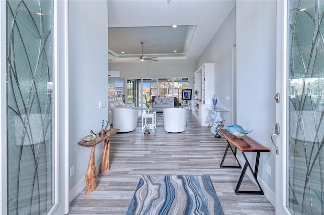 1450 Kiwi Ct, Punta Gorda, FL 33950 - hallway with a tray ceiling, wood finished floors, baseboards, and recessed lighting