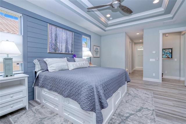 1450 Kiwi Ct, Punta Gorda, FL 33950 - bedroom with light wood-type flooring, baseboards, recessed lighting, a ceiling fan, and a tray ceiling