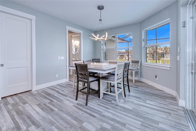 dining room featuring a chandelier and light hardwood / wood-style floors