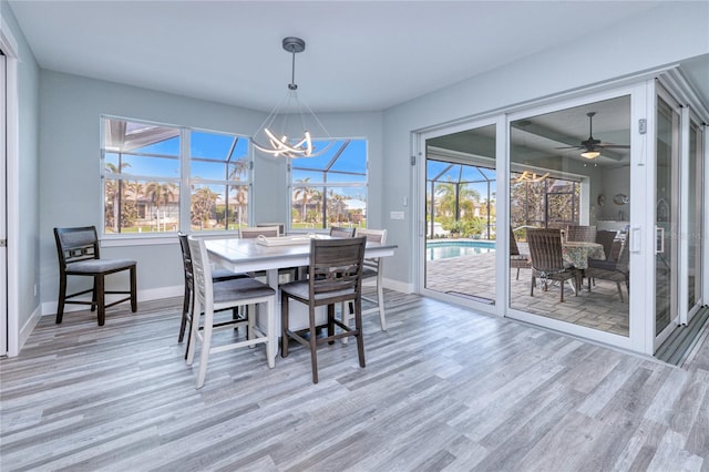 dining room featuring a wealth of natural light, ceiling fan, and wood-type flooring