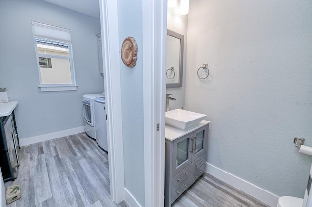 bathroom featuring vanity, separate washer and dryer, and hardwood / wood-style flooring