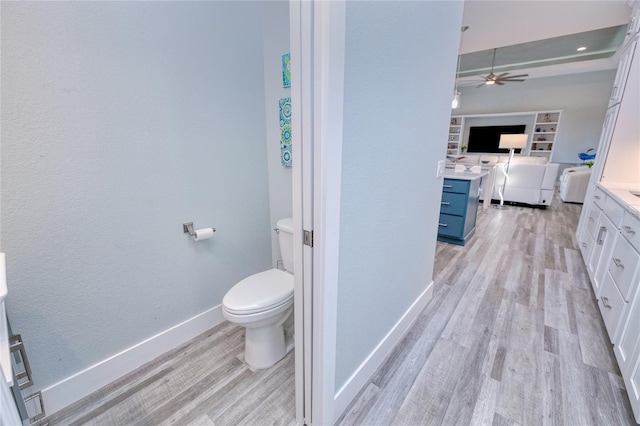 bathroom featuring vanity, toilet, ceiling fan, and hardwood / wood-style flooring