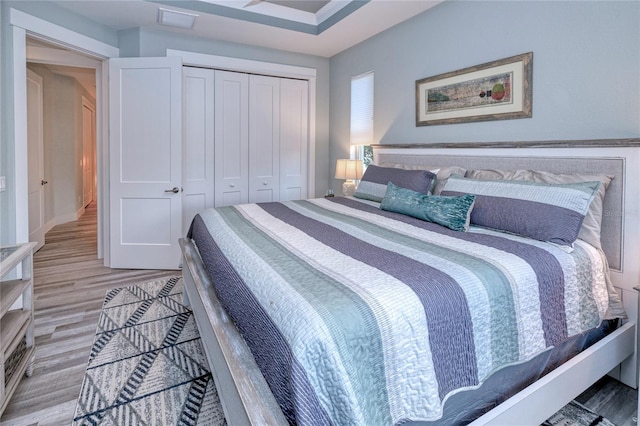 bedroom with a closet and light hardwood / wood-style floors