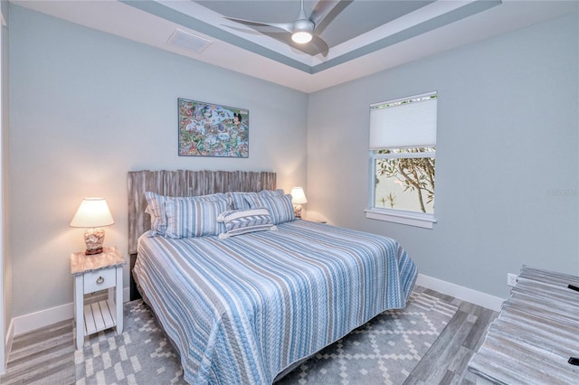 bedroom with dark hardwood / wood-style floors and ceiling fan