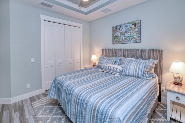 bedroom with a closet and dark wood-type flooring