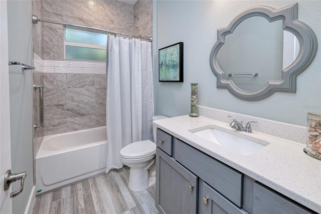 full bathroom featuring hardwood / wood-style floors, vanity, toilet, and shower / bathtub combination with curtain