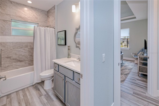 full bathroom with toilet, hardwood / wood-style floors, vanity, and shower / tub combo with curtain