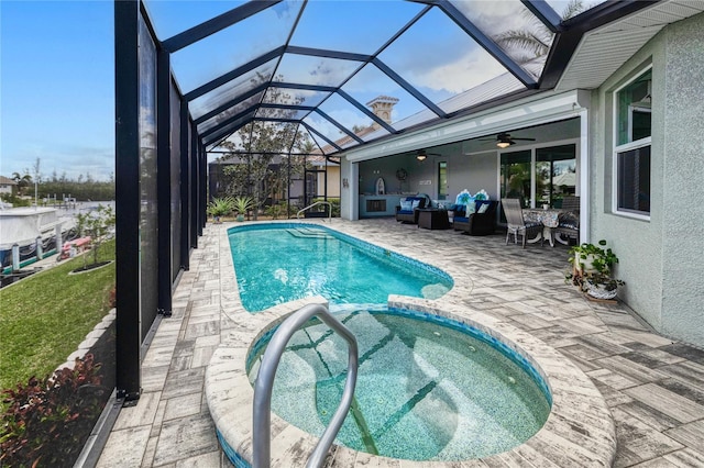 view of swimming pool with outdoor lounge area, a patio area, a lanai, ceiling fan, and an in ground hot tub