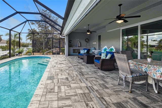 view of swimming pool with outdoor lounge area, a patio area, and glass enclosure