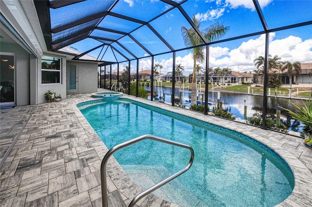 view of pool featuring an in ground hot tub, a water view, and a lanai