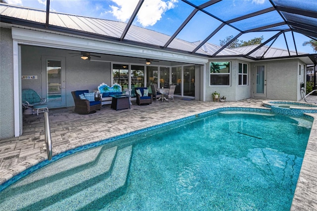 view of pool with outdoor lounge area, ceiling fan, glass enclosure, an in ground hot tub, and a patio