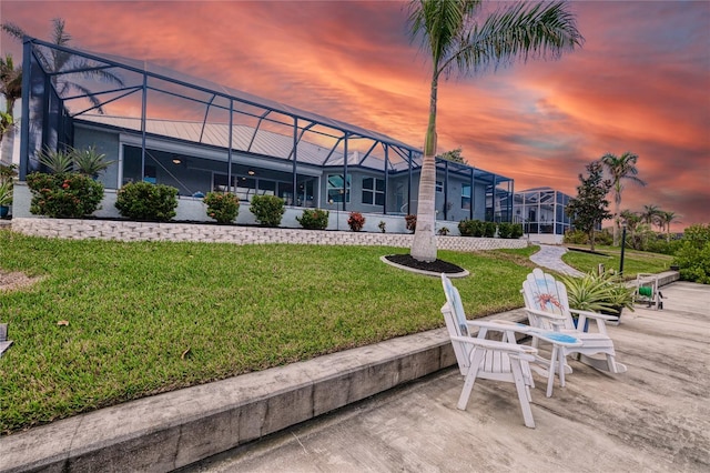 view of home's community featuring a lawn and a patio