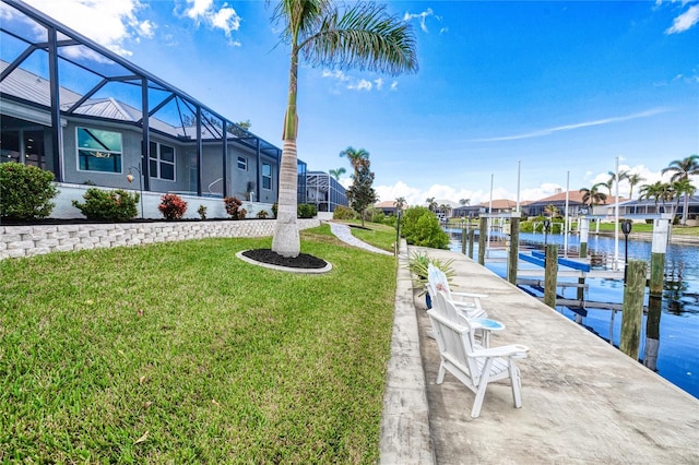 dock area featuring a lanai, a yard, and a water view