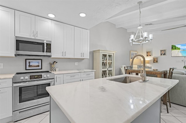 kitchen with white cabinetry, light tile patterned floors, a center island with sink, and stainless steel appliances