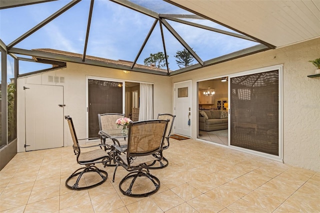 sunroom with a healthy amount of sunlight and vaulted ceiling