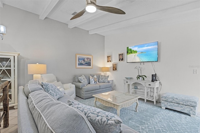 living room featuring ceiling fan, beam ceiling, and light tile patterned floors