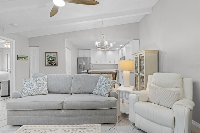 tiled living room featuring ceiling fan with notable chandelier, sink, and vaulted ceiling with beams