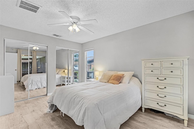 bedroom featuring a textured ceiling, ceiling fan, and light hardwood / wood-style flooring