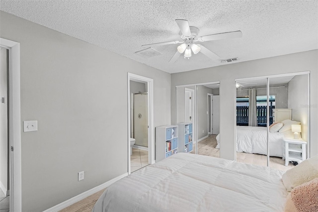 bedroom featuring light hardwood / wood-style flooring, a textured ceiling, ceiling fan, and ensuite bathroom