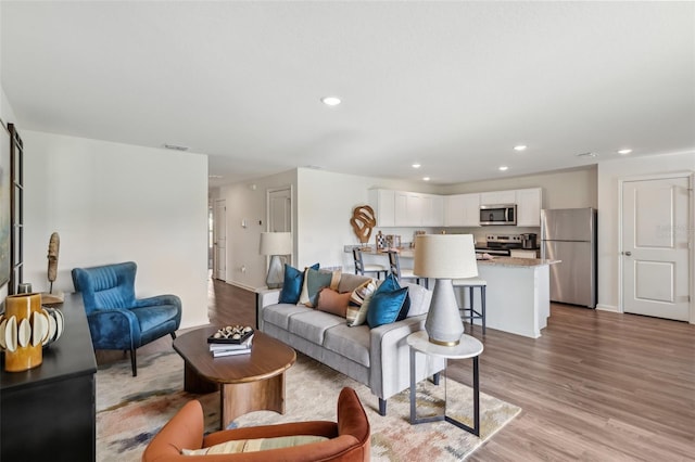 16307 Alcira Cir, Punta Gorda, FL 33955 - living room featuring light wood finished floors and recessed lighting