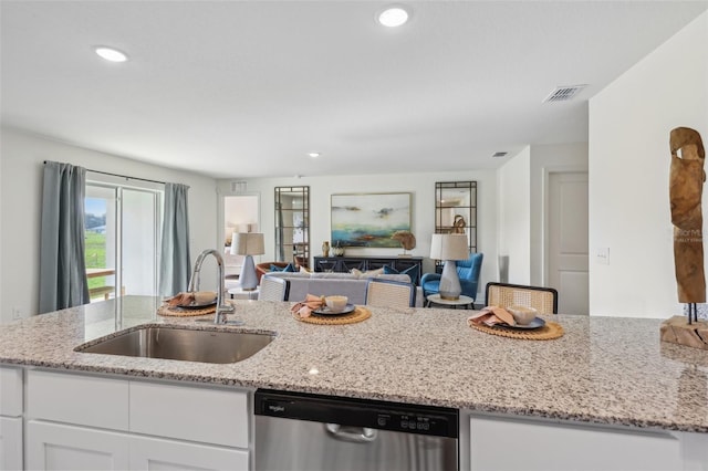 16307 Alcira Cir, Punta Gorda, FL 33955 - kitchen featuring dishwasher, open floor plan, white cabinets, light stone counters, and recessed lighting