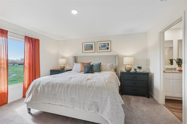 16307 Alcira Cir, Punta Gorda, FL 33955 - bedroom featuring carpet flooring, ensuite bath, and recessed lighting