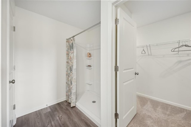 16307 Alcira Cir, Punta Gorda, FL 33955 - full bath featuring a shower with curtain, a spacious closet, and wood finished floors