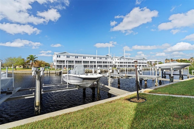 dock area with a lawn and a water view