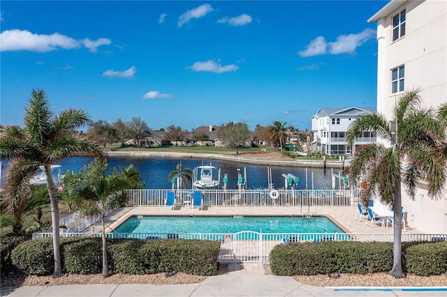 view of swimming pool with a water view and a patio area