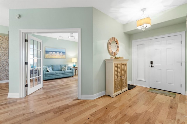 foyer entrance with light wood-type flooring